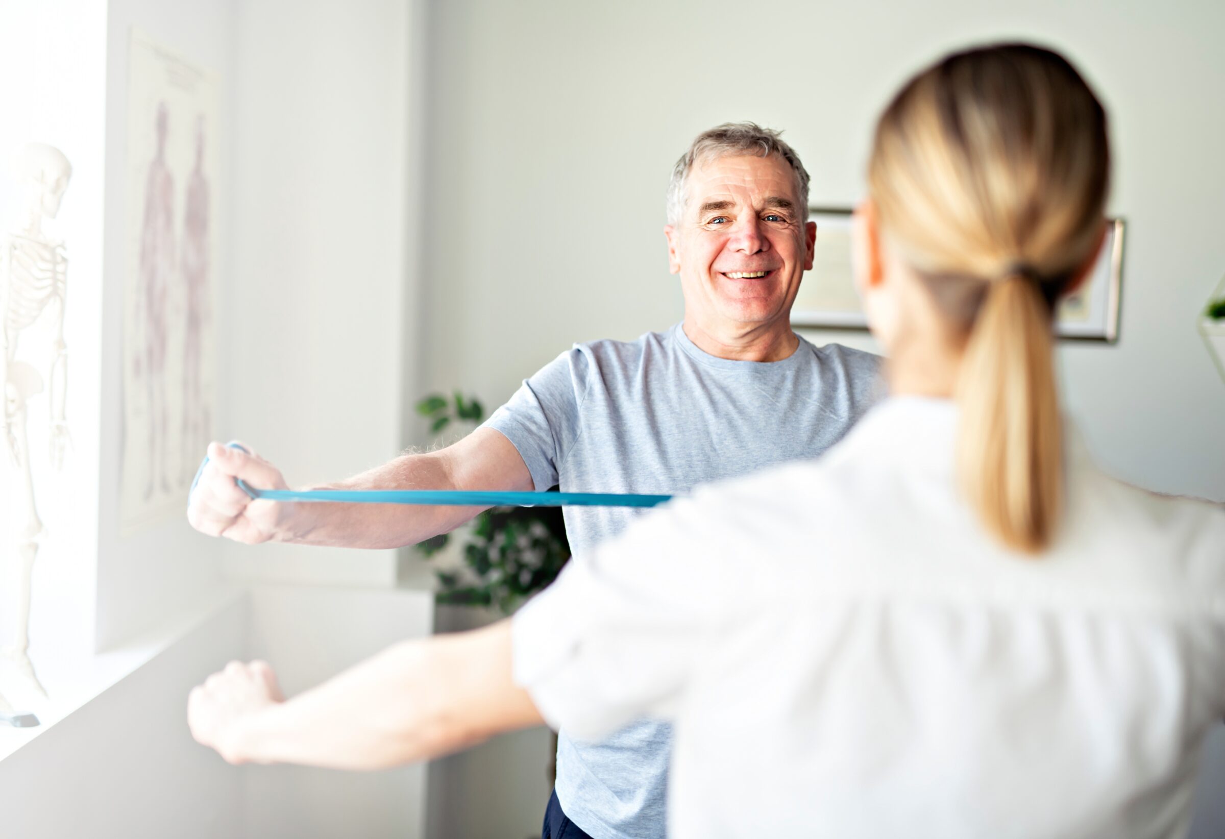 A Modern rehabilitation physiotherapy worker with senior client